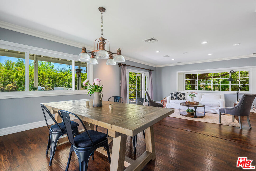 24975 Kit Carson Road Hidden Hills, CA 91302 - Photo 12 of 38 a view of a dining room with furniture window and wooden floor