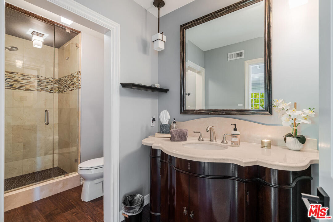 24975 Kit Carson Road Hidden Hills, CA 91302 - Photo 18 of 38 a bathroom with a sink and a mirror