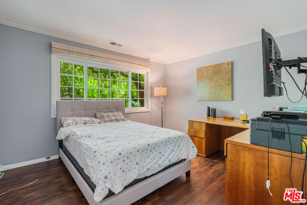 24975 Kit Carson Road Hidden Hills, CA 91302 - Photo 19 of 38 a bedroom with a bed and a flat screen tv