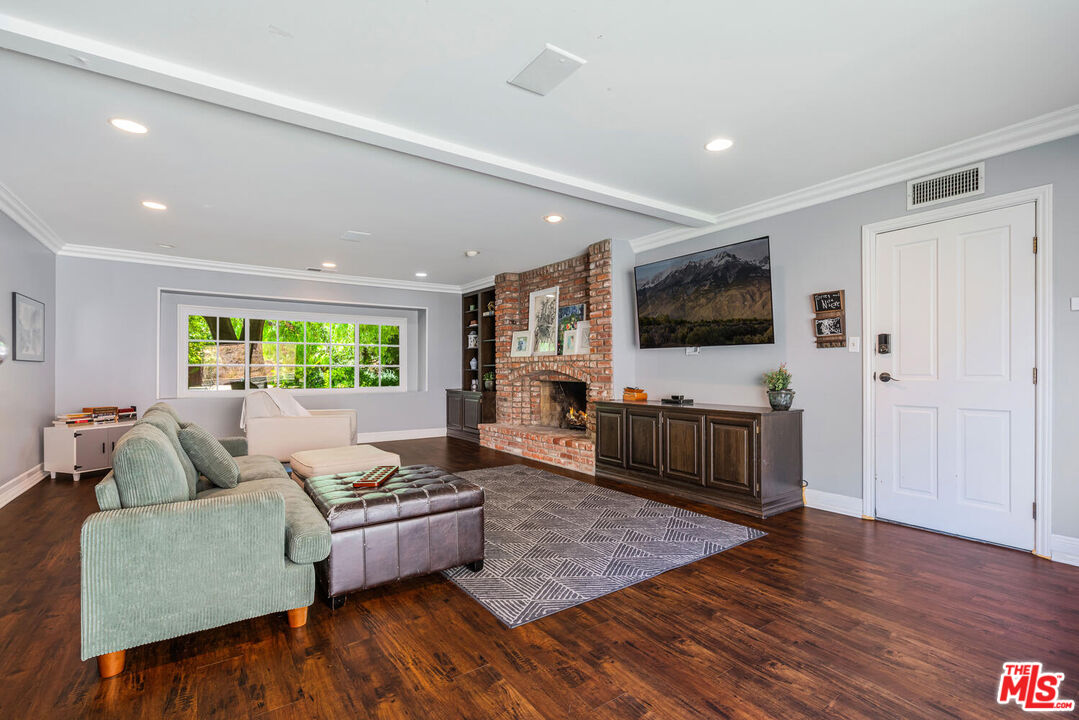 24975 Kit Carson Road Hidden Hills, CA 91302 - Photo 20 of 38 a living room with furniture and a flat screen tv