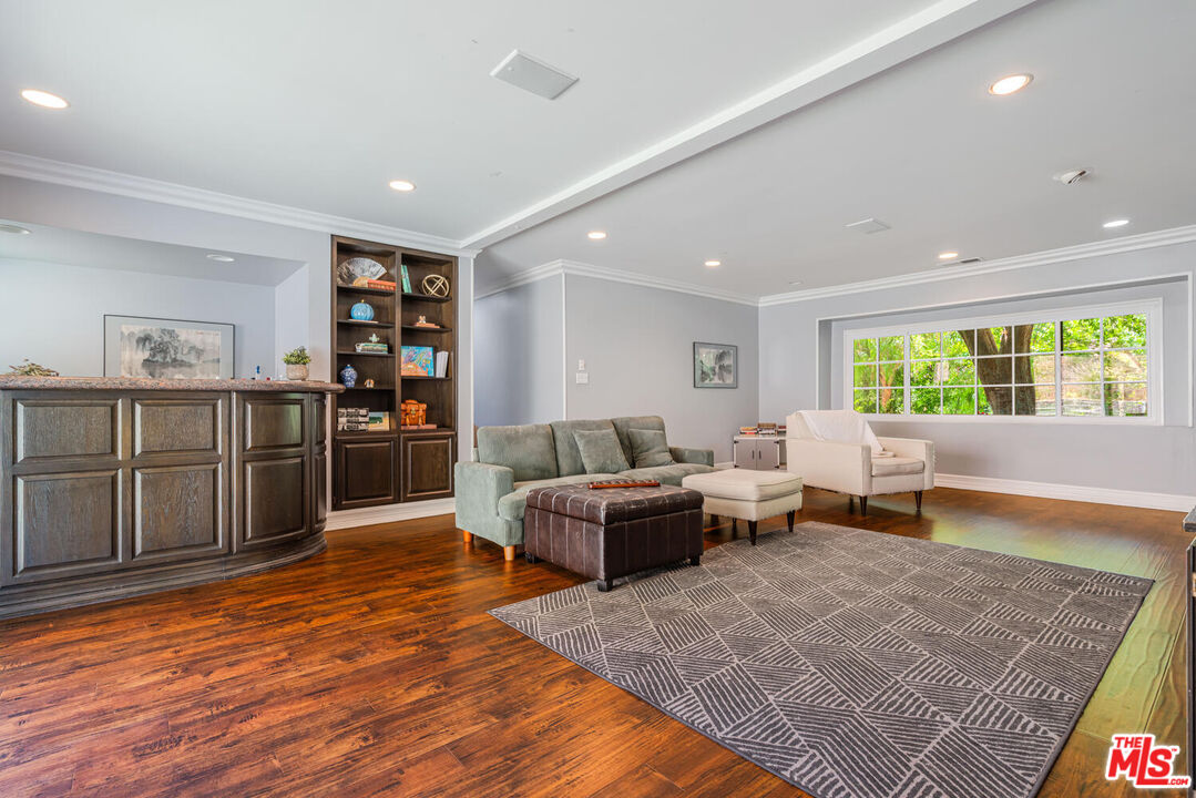 24975 Kit Carson Road Hidden Hills, CA 91302 - Photo 22 of 38 a living room with furniture and a wooden floor