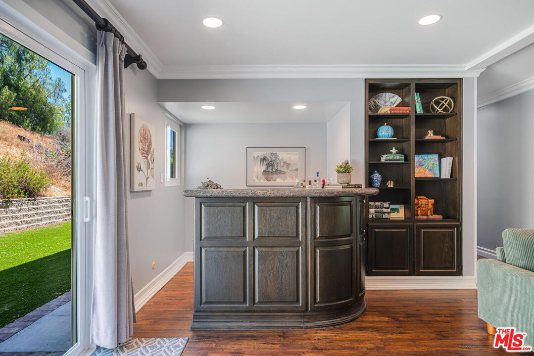 24975 Kit Carson Road Hidden Hills, CA 91302 - Photo 23 of 38 a kitchen with stainless steel appliances granite countertop a refrigerator and a stove