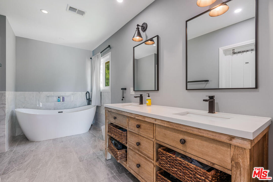 24975 Kit Carson Road Hidden Hills, CA 91302 - Photo 26 of 38 a spacious bathroom with a double vanity sink mirror and bathtub