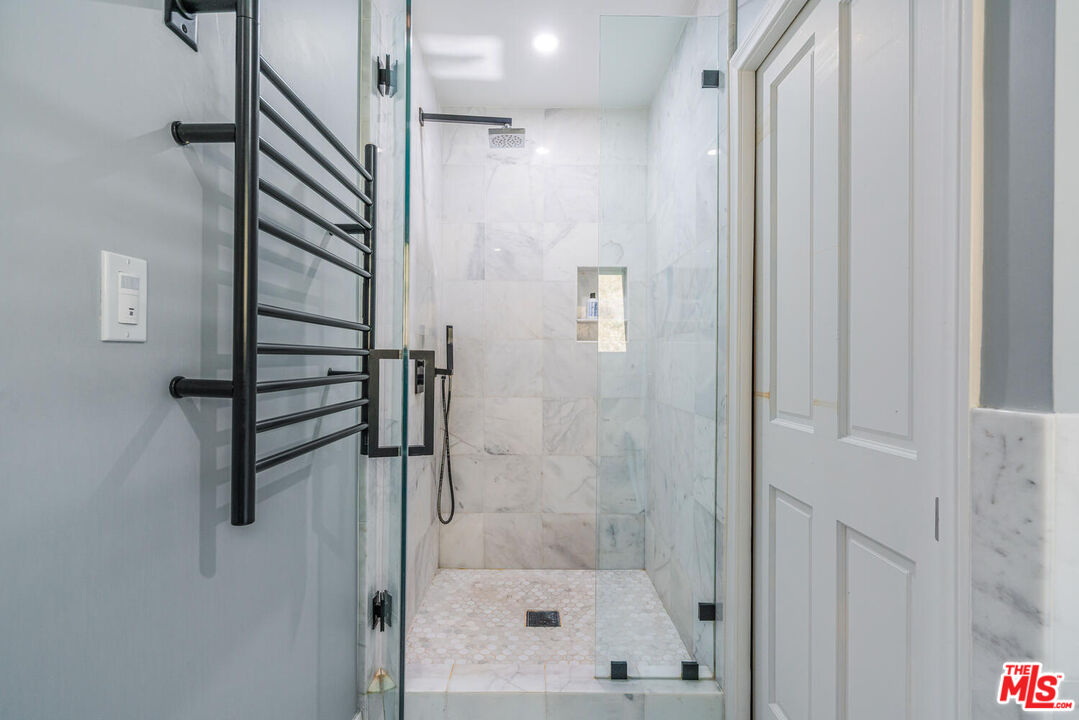 24975 Kit Carson Road Hidden Hills, CA 91302 - Photo 27 of 38 a bathroom with a shower