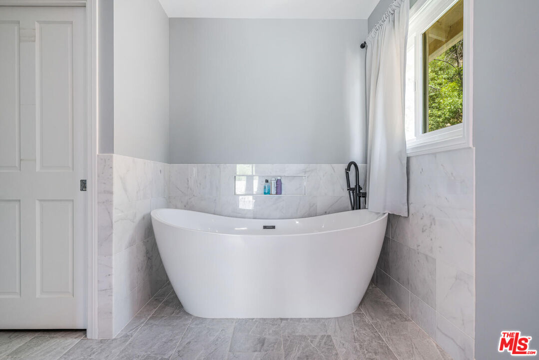 24975 Kit Carson Road Hidden Hills, CA 91302 - Photo 28 of 38 a white bath tub sitting in a bathroom