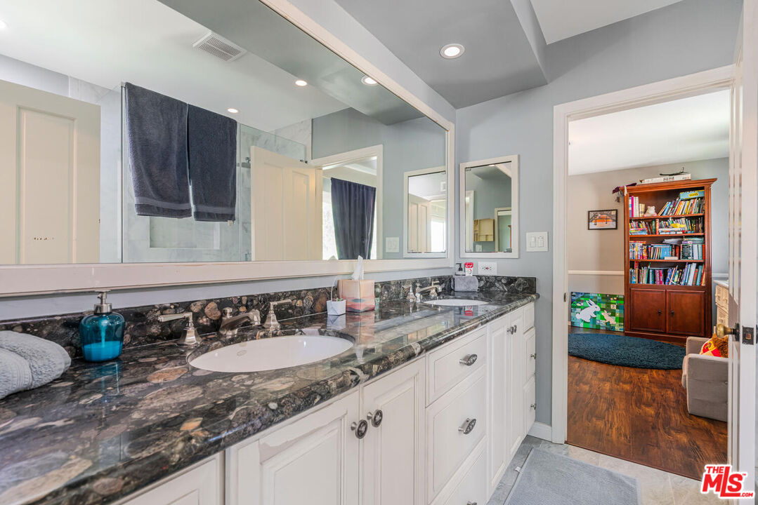 24975 Kit Carson Road Hidden Hills, CA 91302 - Photo 30 of 38 a bathroom with a sink and a mirror