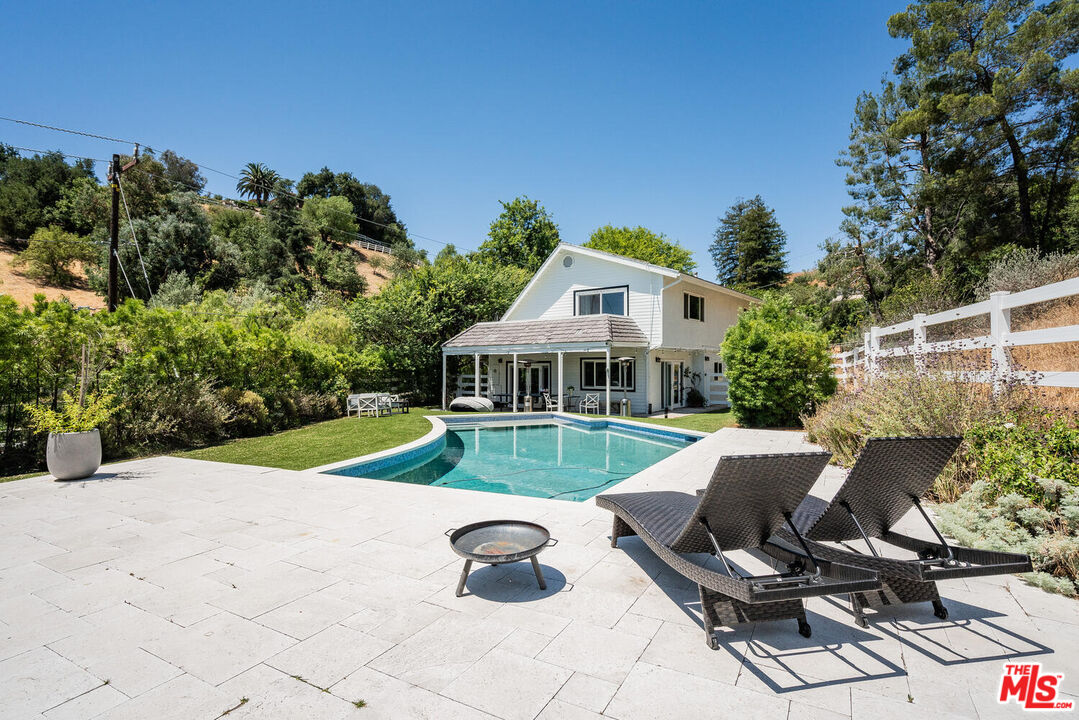 24975 Kit Carson Road Hidden Hills, CA 91302 - Photo 3 of 38 a view of a house with backyard sitting area and garden