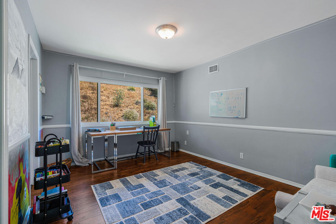 24975 Kit Carson Road Hidden Hills, CA 91302 - Photo 33 of 38 a room with furniture and a window