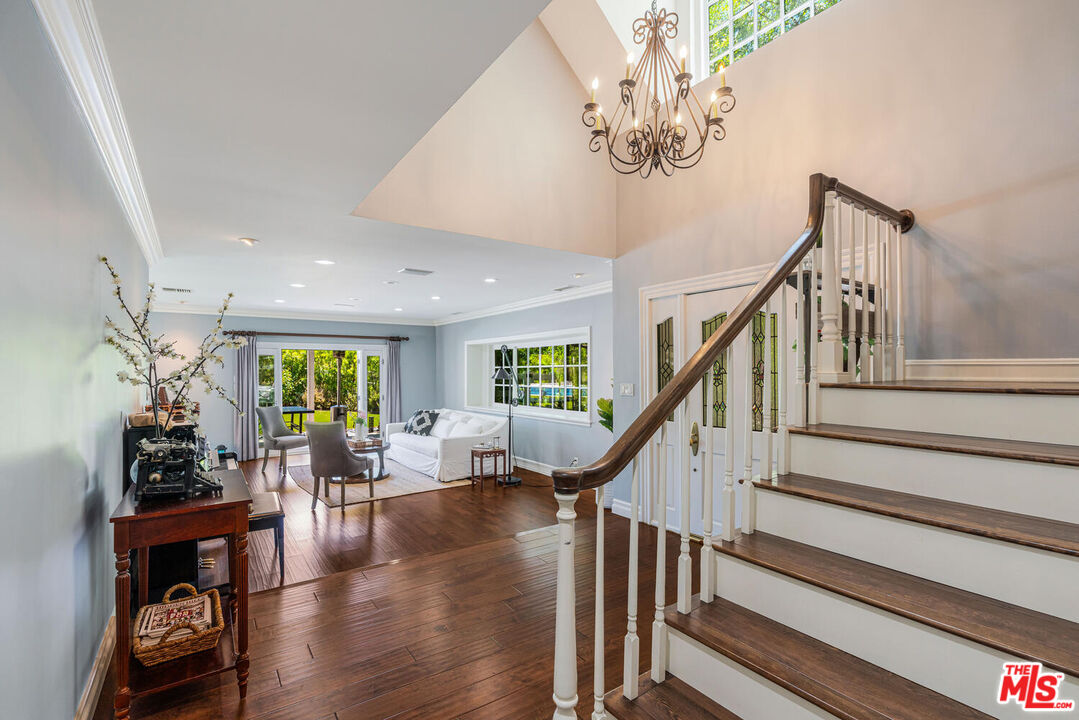 24975 Kit Carson Road Hidden Hills, CA 91302 - Photo 7 of 38 a living room with furniture and a chandelier