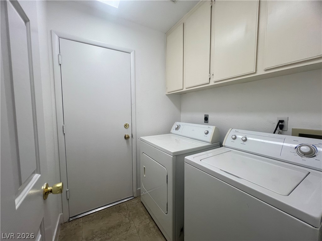 1309 Goldenglow Road Las Vegas, NV 89108 - Photo 11 of 11 Ample storage above the washer and dryer simplifies laundry day.