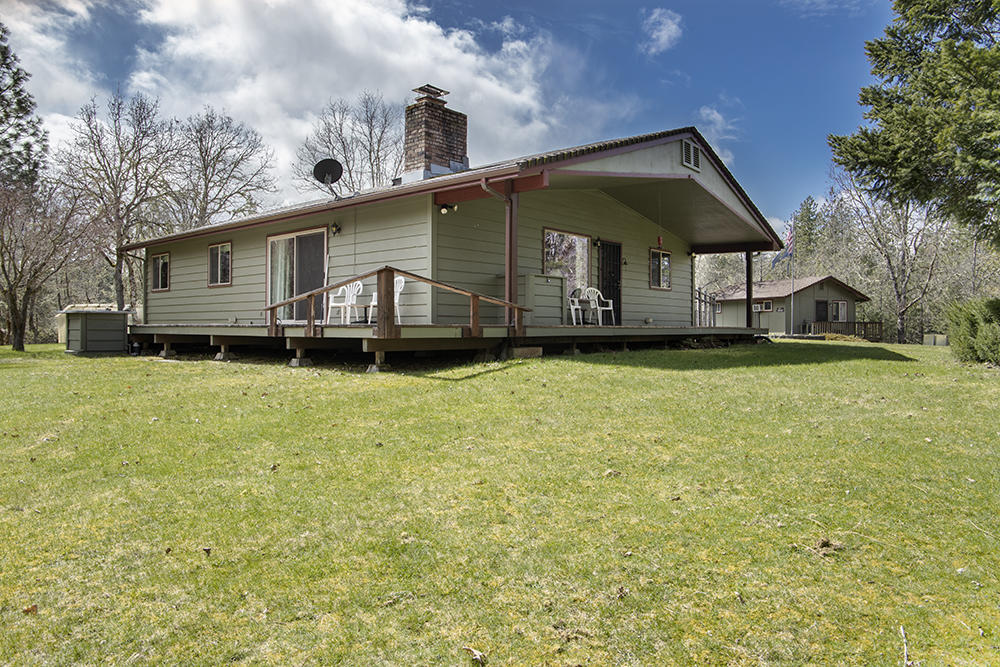 1735 Robertson Bridge Road Grants Pass, OR 97526 - Photo 20 of 47 a front view of a house with a garden