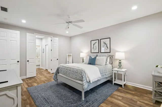 a spacious bedroom with a bed and a dresser