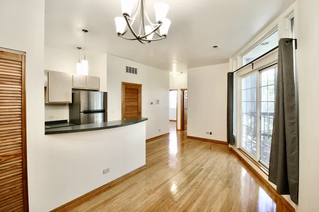 a view of a kitchen with a sink and wooden floor