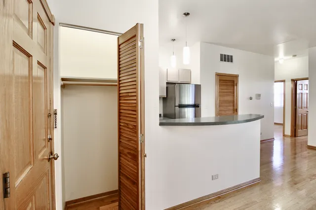 a view of a kitchen with furniture and wooden floor