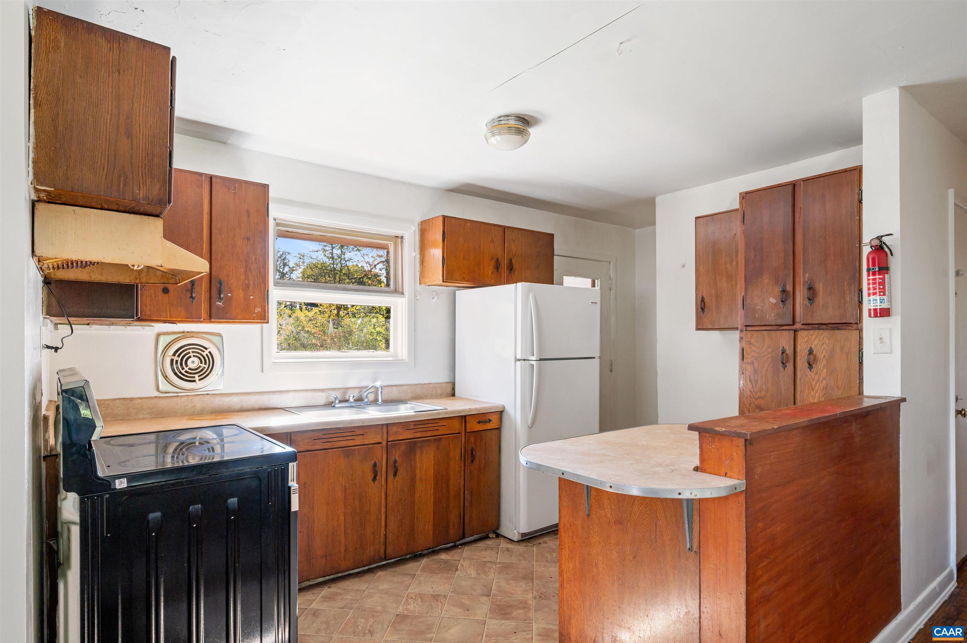 2302 Summit Road Charlottesville, VA 22901 - Photo 12 of 39 a kitchen with a sink a refrigerator and a stove