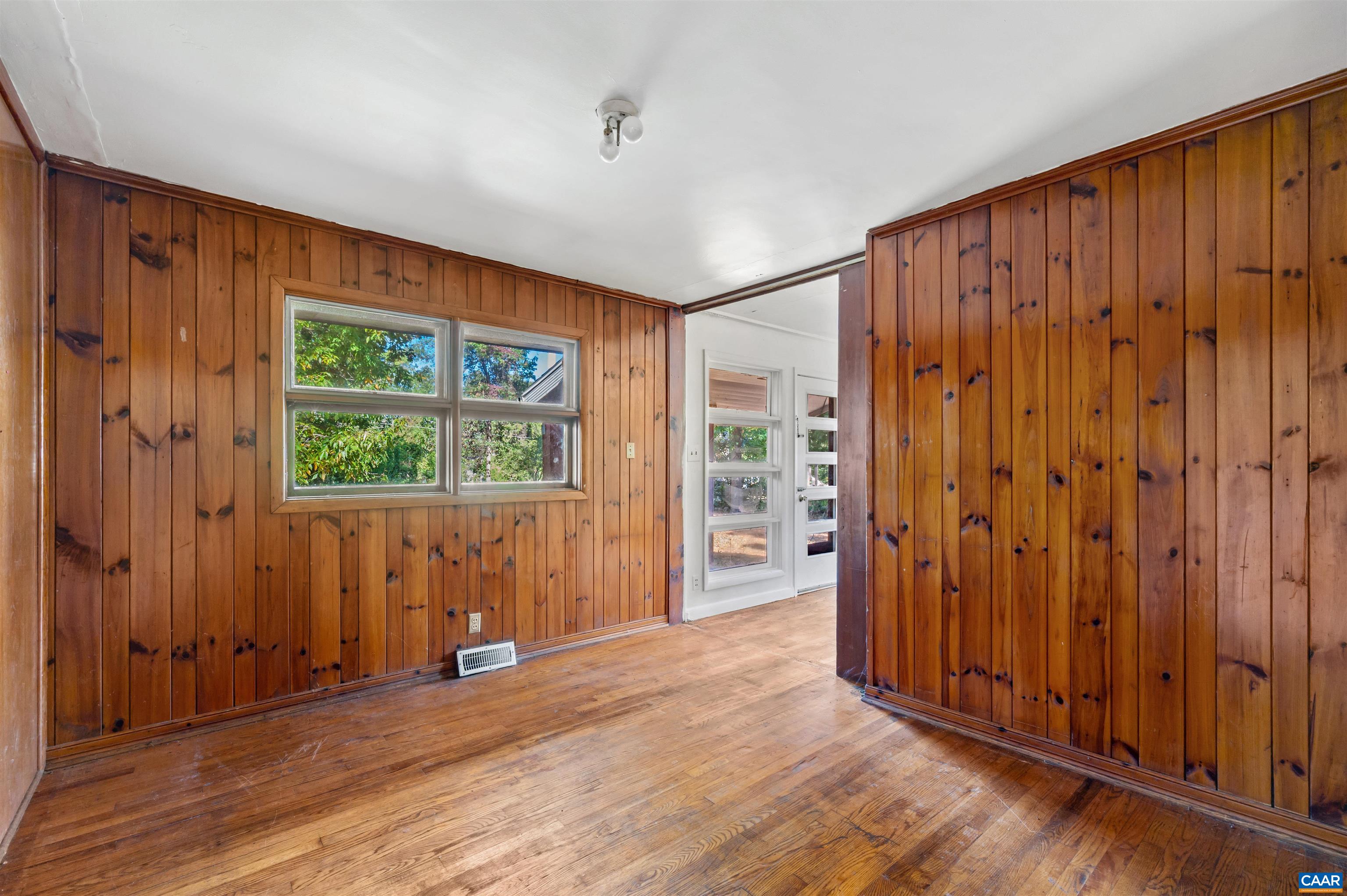 2302 Summit Road Charlottesville, VA 22901 - Photo 20 of 39 an empty room with wooden floor and windows