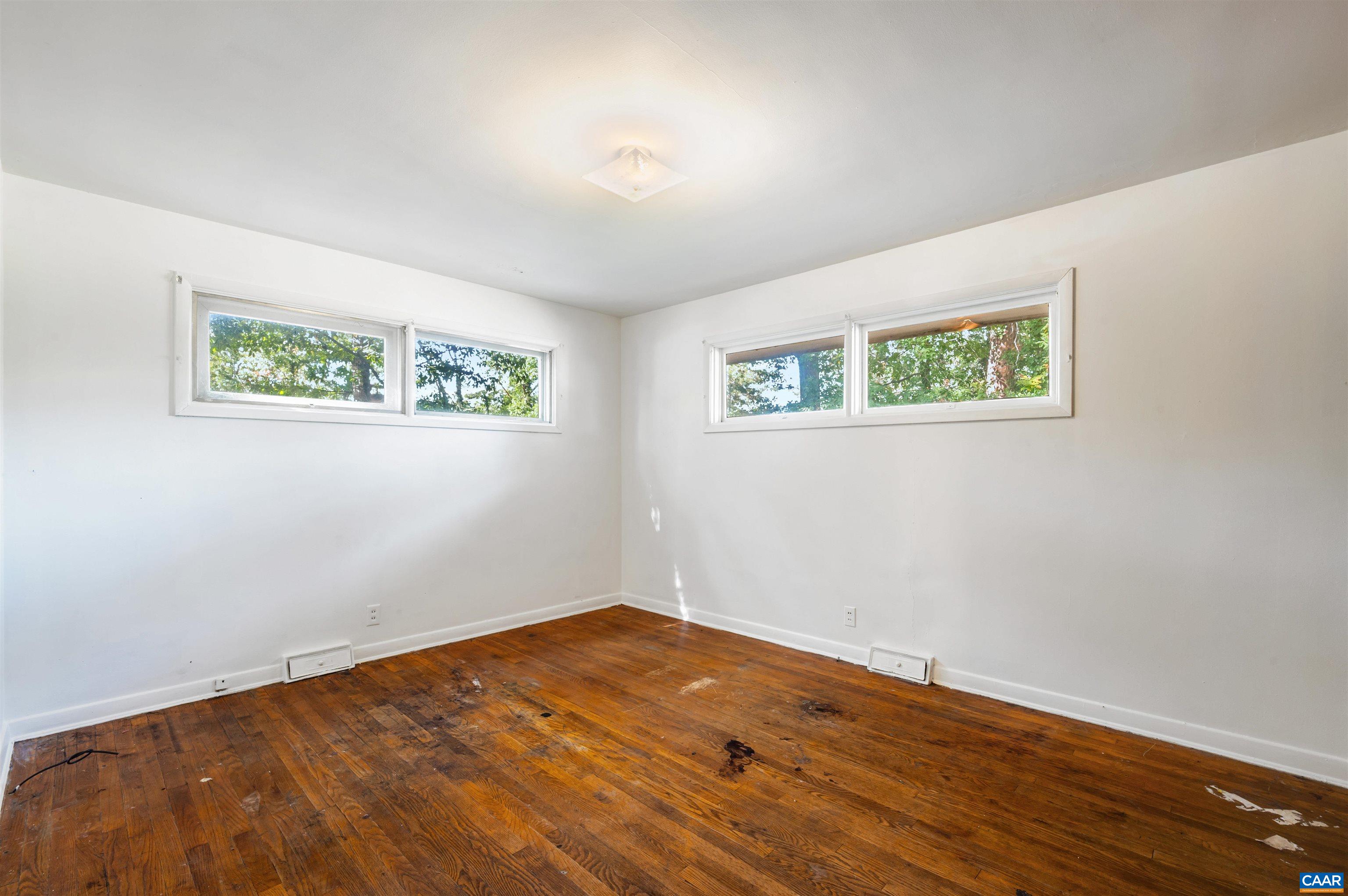 2302 Summit Road Charlottesville, VA 22901 - Photo 21 of 39 a view of an empty room with wooden floor and window