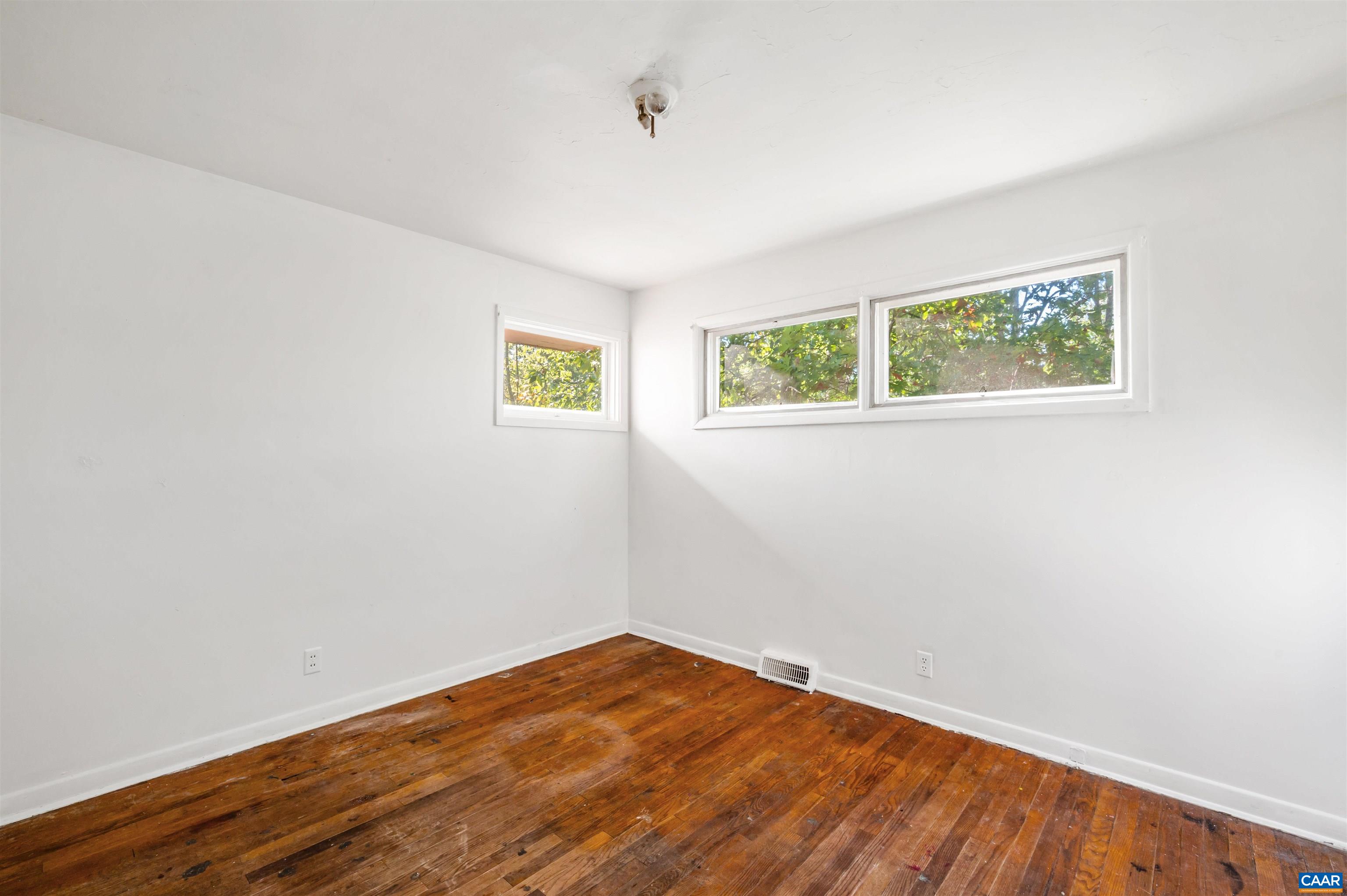 2302 Summit Road Charlottesville, VA 22901 - Photo 26 of 39 an empty room with wooden floor and windows