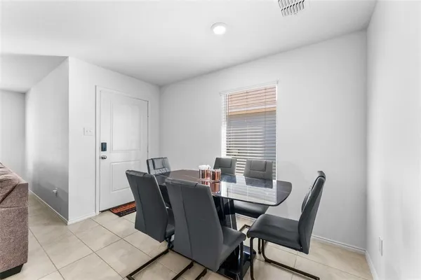 a view of a dining room with furniture and window