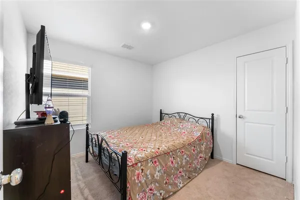 a bedroom with a bed and a dresser