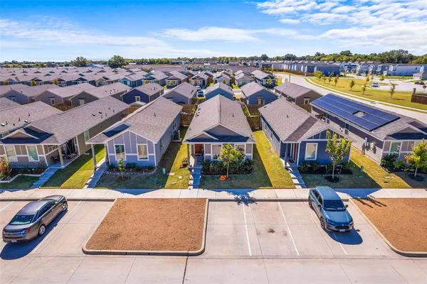 an aerial view of residential houses with outdoor space