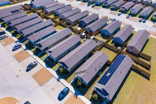 an aerial view of residential houses with outdoor space