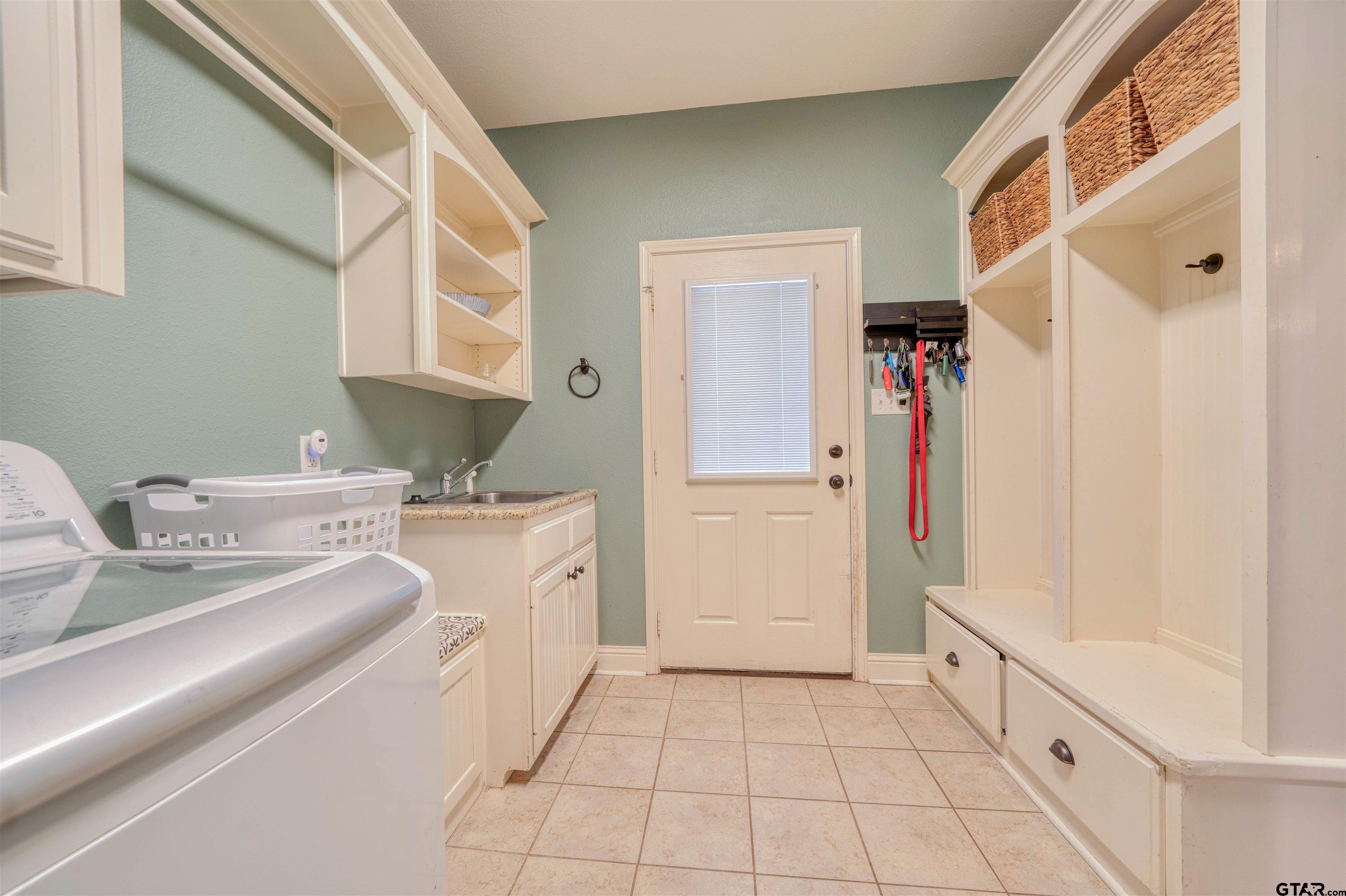 1776 Mustang Road Gilmer, TX 75645 - Photo 22 of 45 a bathroom with a sink a mirror and a shower