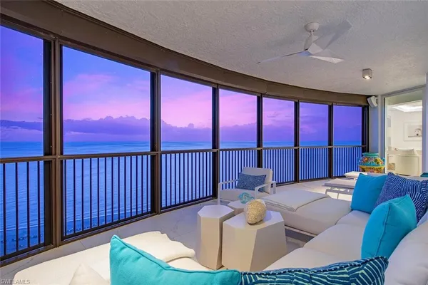 a living room with fireplace furniture and a large window