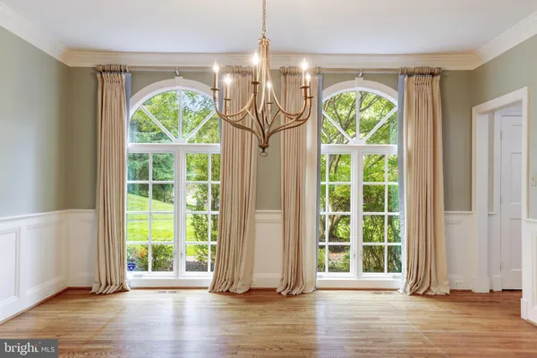 a view of an entryway with wooden floor and windows