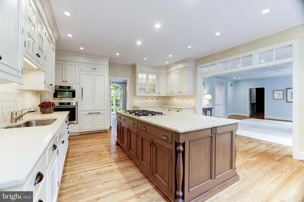 a kitchen with a stove sink and a refrigerator