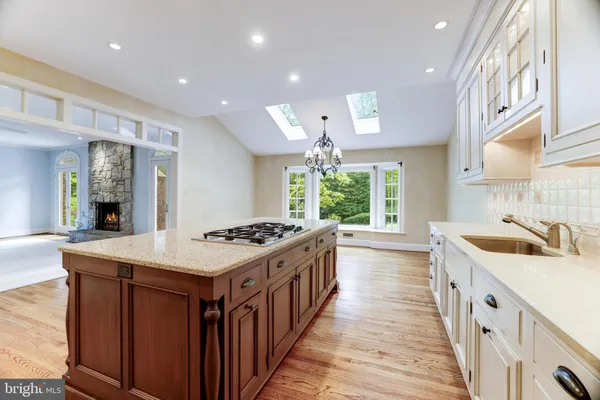 a kitchen with stainless steel appliances a sink stove and cabinets