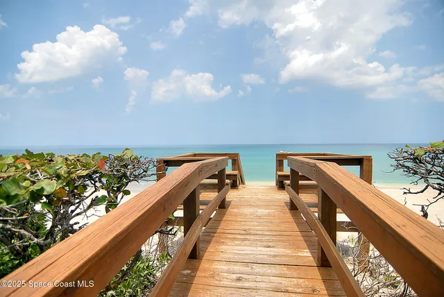 a balcony with wooden floor and city view