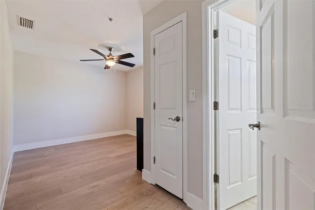 a view of an empty room with a ceiling fan