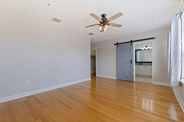 a view of empty room with wooden floor
