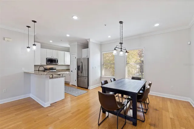 a view of a dining room with furniture window and wooden floor