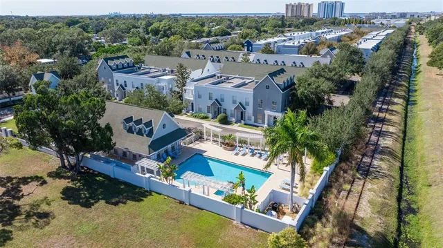 an aerial view of multiple houses with yard
