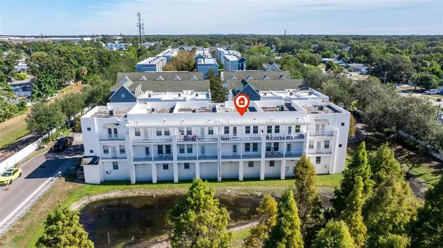 a view of a big building with a big yard and large trees