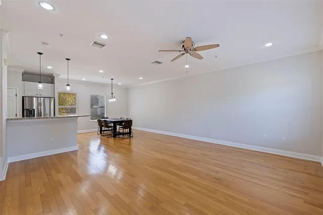 a view of empty room with wooden floor and a table