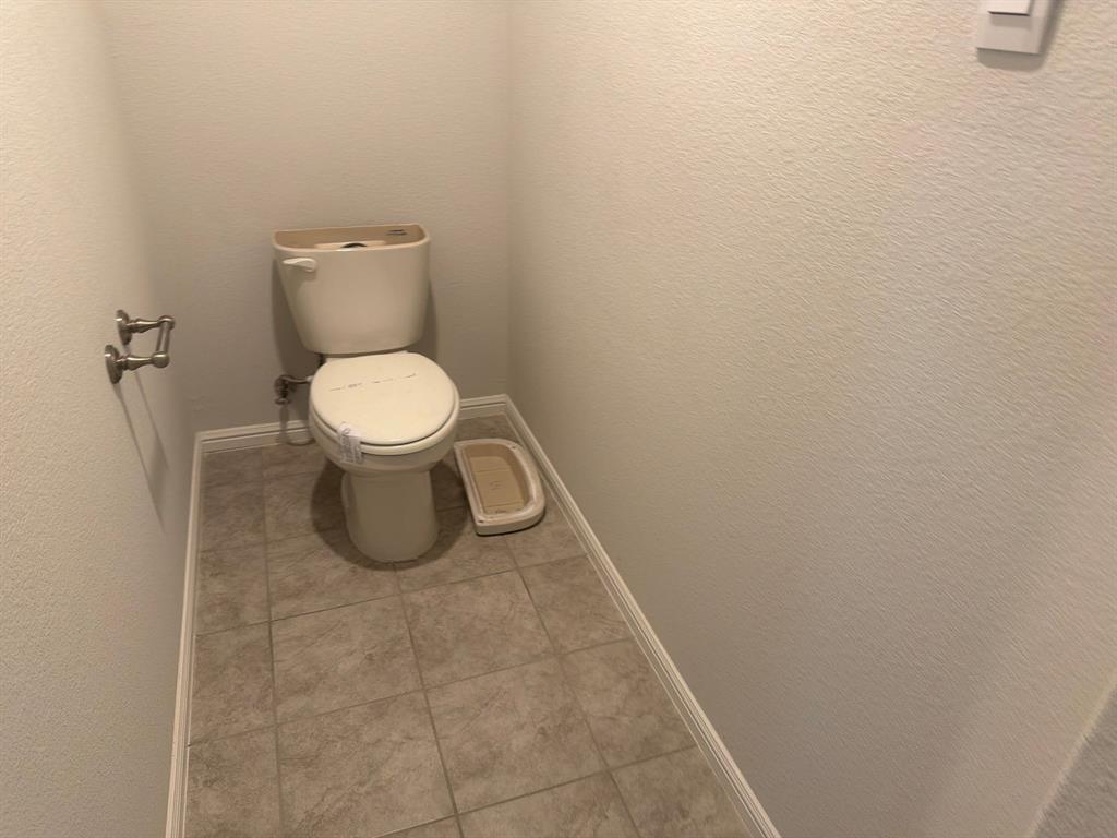 721 Durango Lane Cleburne, TX 76033 - Photo 11 of 25 a white toilet sitting next to a shower
