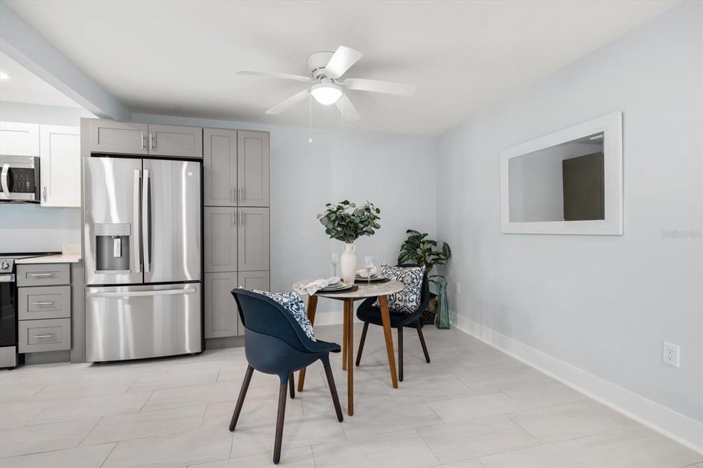1 Windrush Boulevard, Unit 45 Indian Rocks Beach, FL 33785 - Photo 16 of 53 a view of a dining room with furniture window and wooden floor