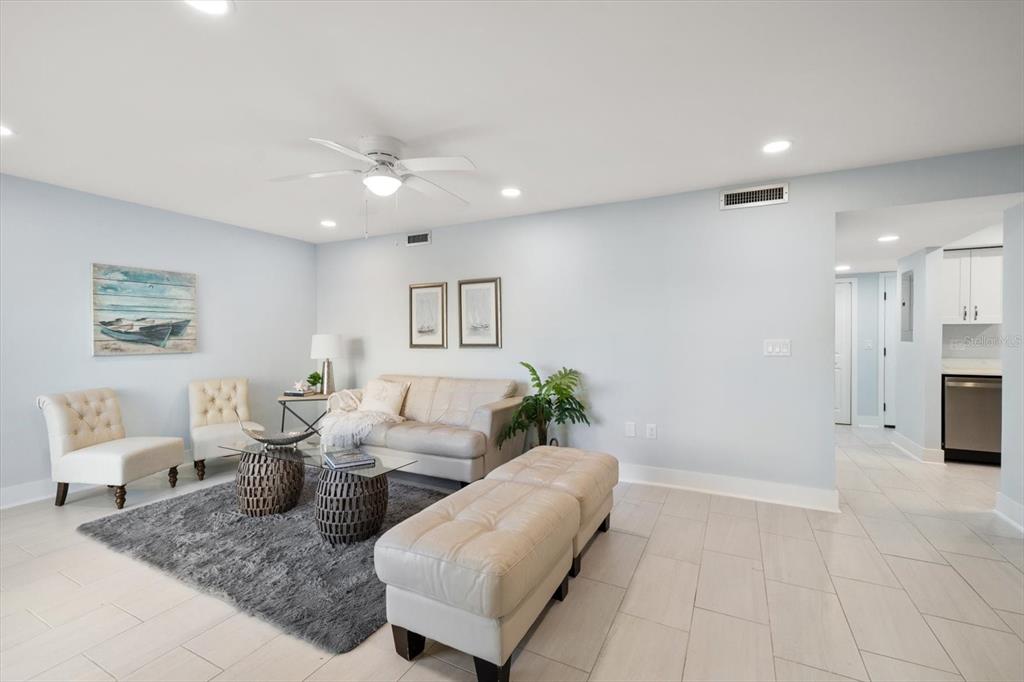 1 Windrush Boulevard, Unit 45 Indian Rocks Beach, FL 33785 - Photo 19 of 53 a living room with furniture and a chandelier