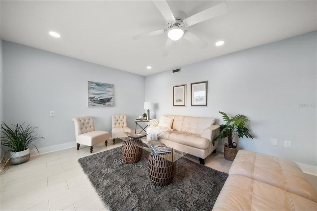 1 Windrush Boulevard, Unit 45 Indian Rocks Beach, FL 33785 - Photo 20 of 53 a living room with furniture and a potted plant