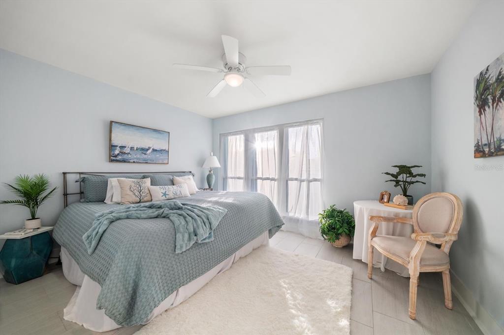 1 Windrush Boulevard, Unit 45 Indian Rocks Beach, FL 33785 - Photo 26 of 53 a bed room with a bed and a chair