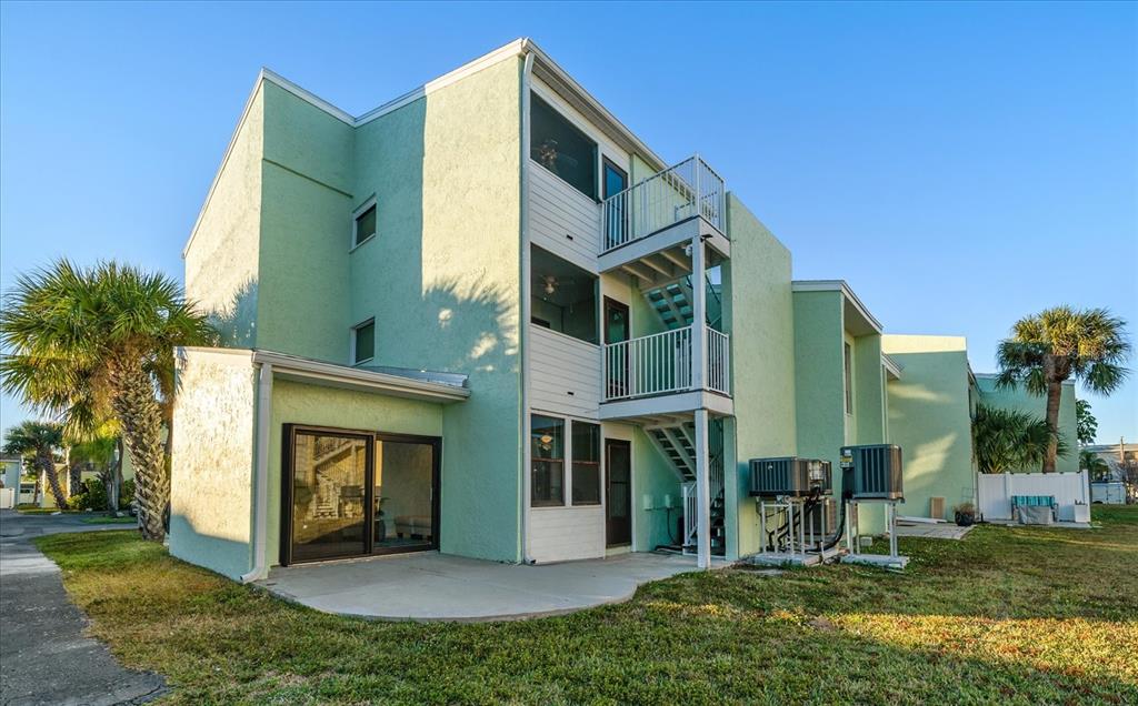 1 Windrush Boulevard, Unit 45 Indian Rocks Beach, FL 33785 - Photo 33 of 53 a view of a house with a yard and plants