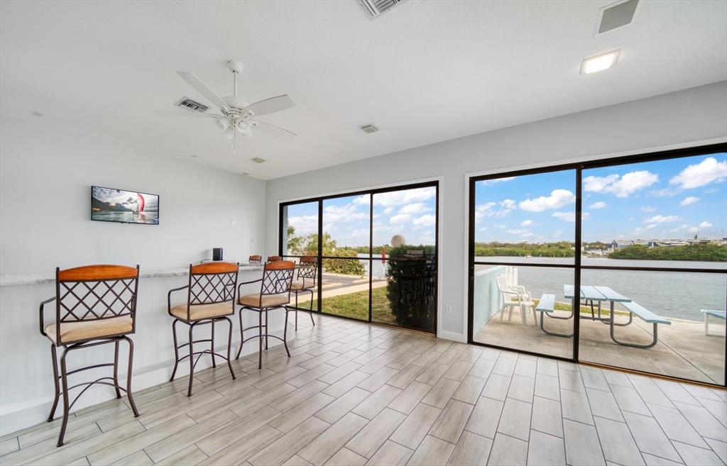 1 Windrush Boulevard, Unit 45 Indian Rocks Beach, FL 33785 - Photo 39 of 53 a living room with furniture and a floor to ceiling window
