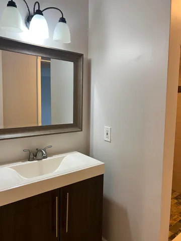 a bathroom with a sink and a mirror