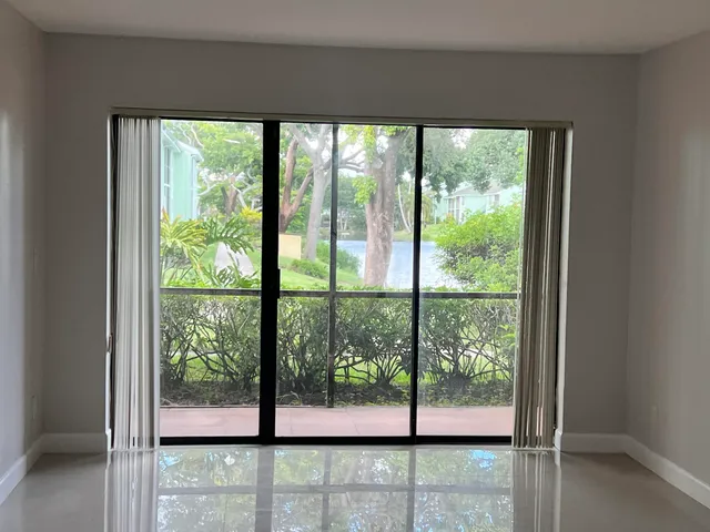 a view of a glass door with a tree in it