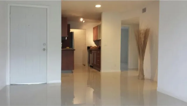 a view of a hallway with wooden shelves