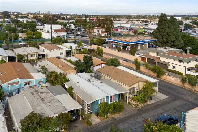 an aerial view of a house with a yard garage and lake view