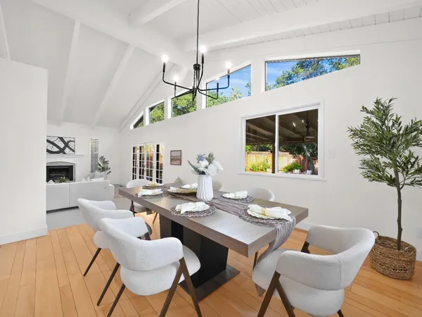 a kitchen with granite countertop white cabinets white appliances a sink and a large window